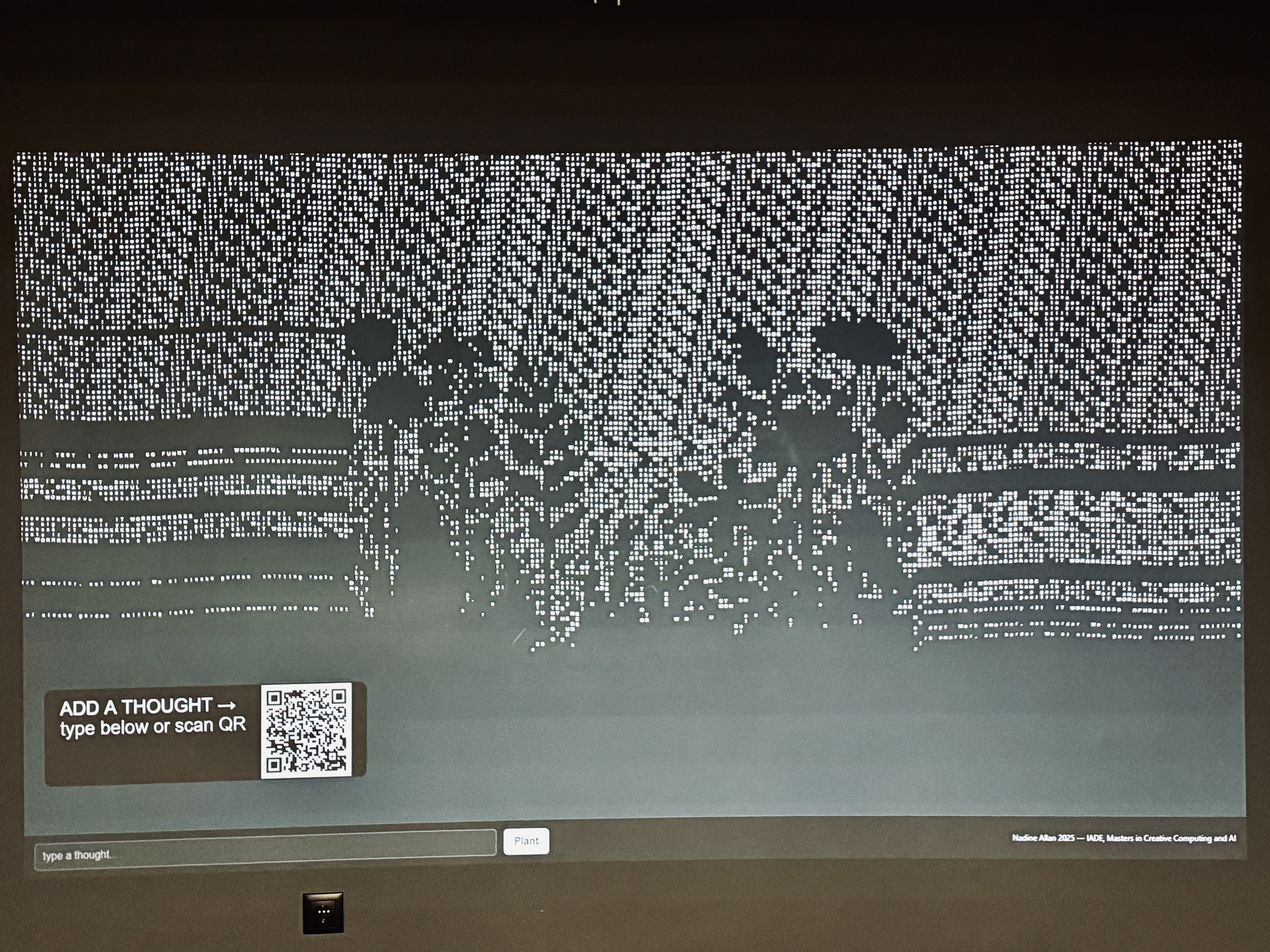 Full wall projection of Echo Garden, with the add-a-thought prompt and QR code visible