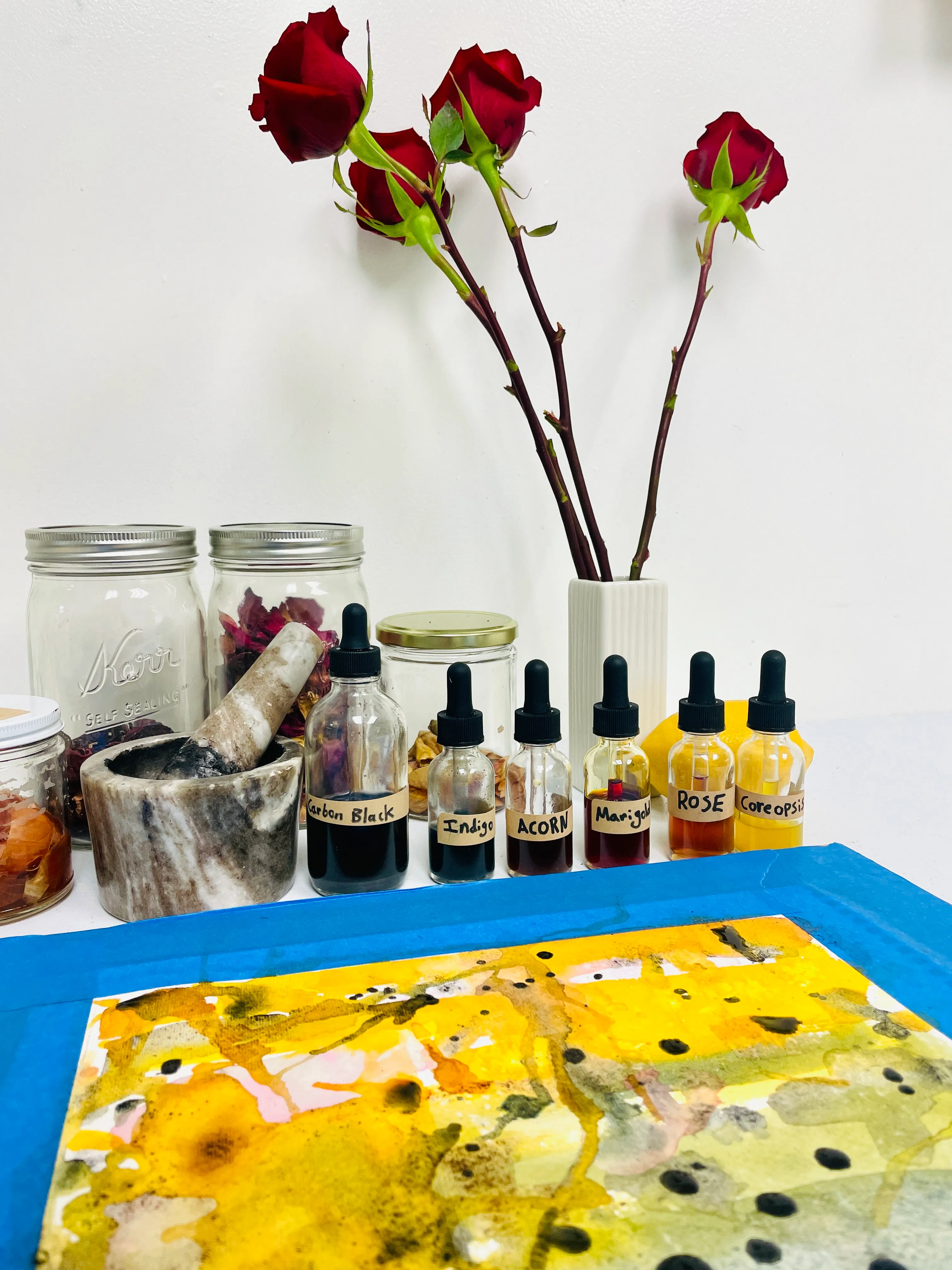 Studio still life: hand-labeled pigment bottles, mortar and pestle, work in progress